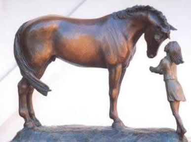 Horse sculpture of young girl with her first horse, sculpture titled  First Love