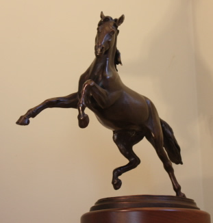 Bronze limited edition of horse sculpture with horse rearing.